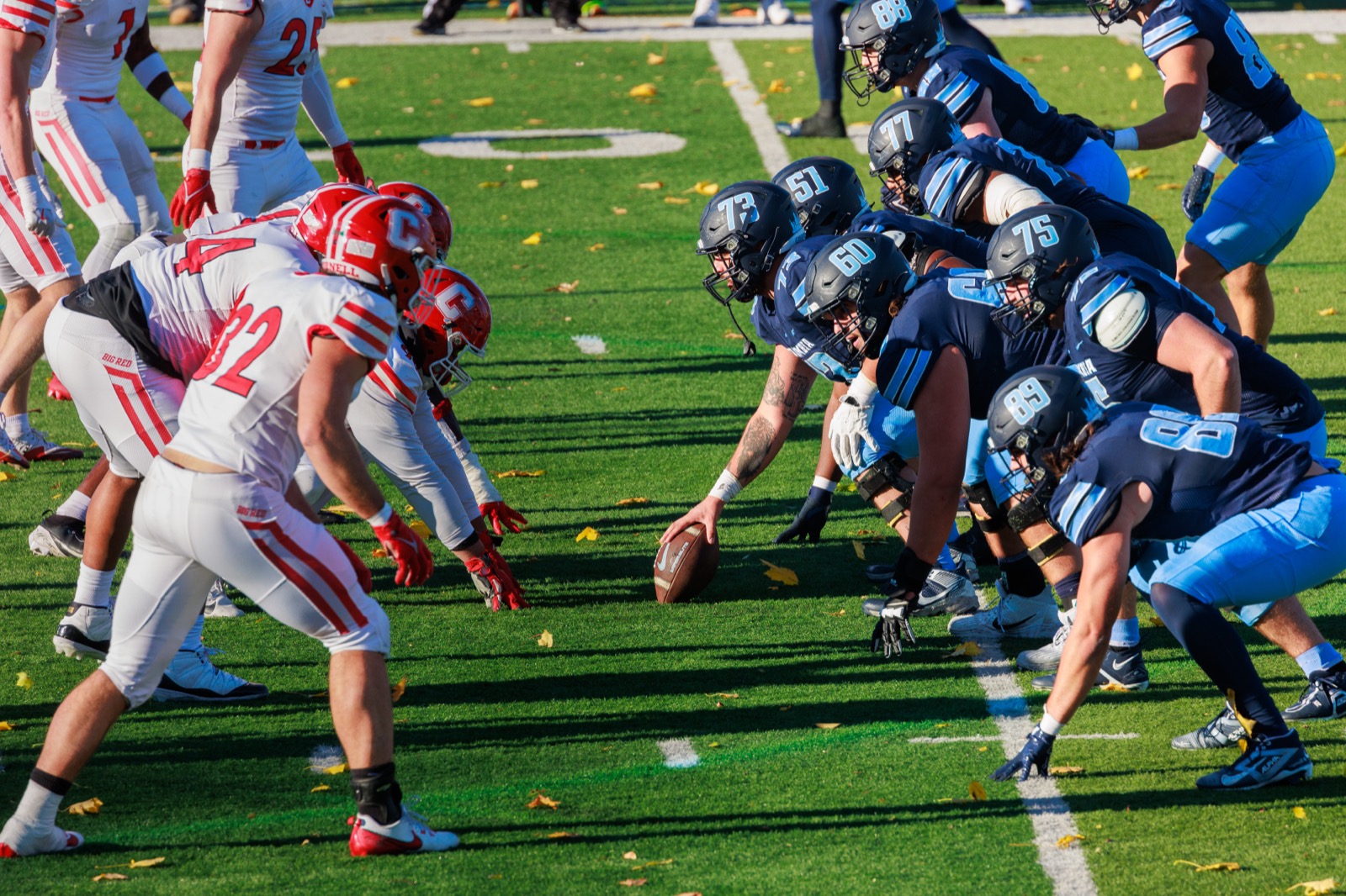 Offensive linemen set at the line of scrimmage before the snap