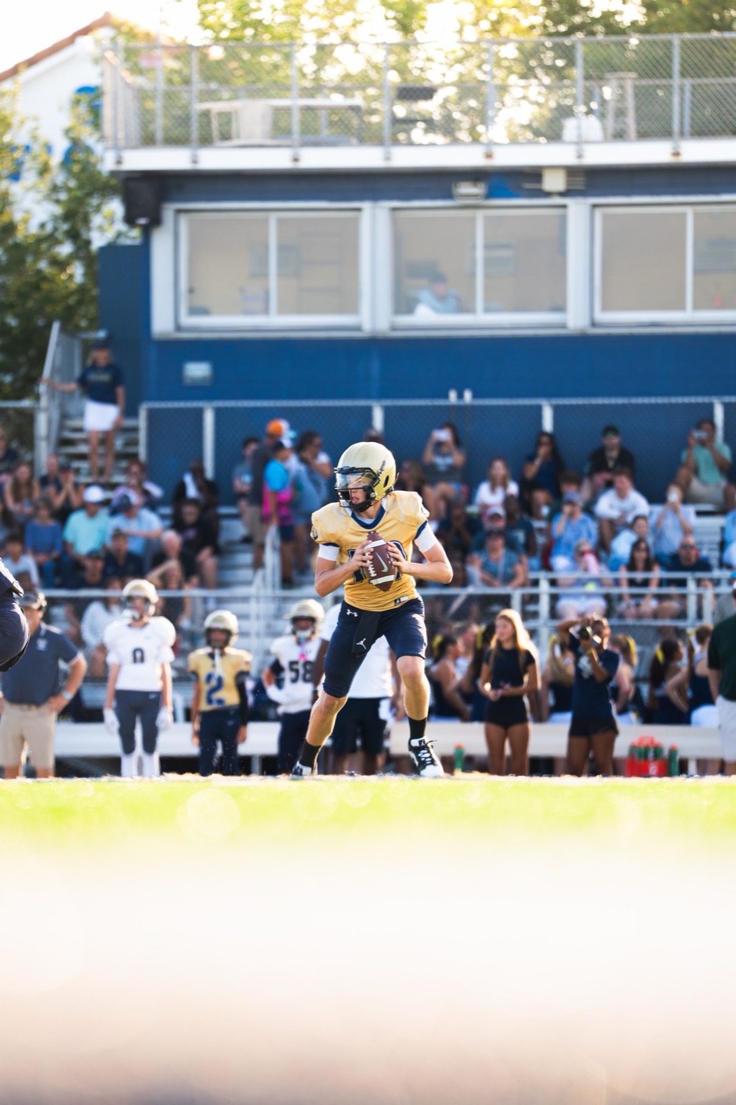 A quarterback set in the pocket before releasing a pass